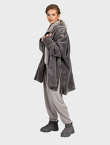Plush smoke pullover sweater hanging on a hanger, highlighting its soft texture and casual style in a light setting.
