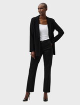 Black slim fit stretch jeans hanging on a hanger, demonstrating their fashionable design and fit.