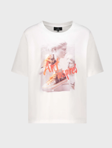 Off-White T-shirt displayed alongside fashionable sneakers, highlighting a contemporary urban fashion aesthetic.