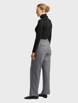 Black turtle neck merino tee folded neatly, showcasing its soft fabric and timeless design for casual wear.