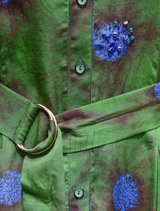 Charming green floral dress with a winter design, featuring a fitted bodice and a flowing skirt for seasonal celebrations.