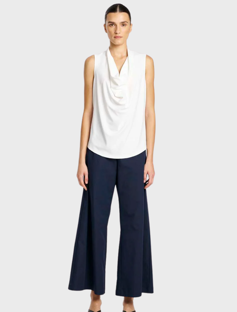 Indigo suit pants displayed on a wooden hanger, showcasing a tailored fit and smooth fabric texture.
