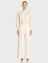 Vanilla and black suit pants displayed on a hanger, showcasing a sleek and professional design.