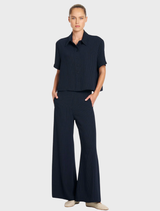 Navy and chalk striped crop shirt with a classic collar and button placket, made from Mela Purdie's Flex Weave fabric.