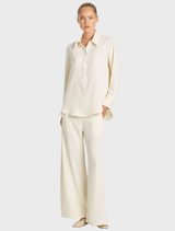 Vanilla and black suit pants displayed on a hanger, showcasing a sleek and professional design.