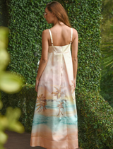 A sunset-inspired dress with a decorative bow at the waist, combining elegance and contemporary fashion.