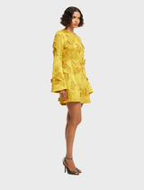 Opulent mini dress adorned with intricate embellishments and flowing bell sleeves, ideal for a chic look.
