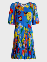 A cobalt floral tunic dress featuring vibrant, colorful flowers throughout the fabric.
