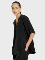 Elegant black Swish Plaza top with a modern cut, perfect for versatile styling options.