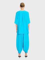  Modern cerulean Swish Plaza Top, crafted from lightweight material, offering a chic look for any casual or formal event.