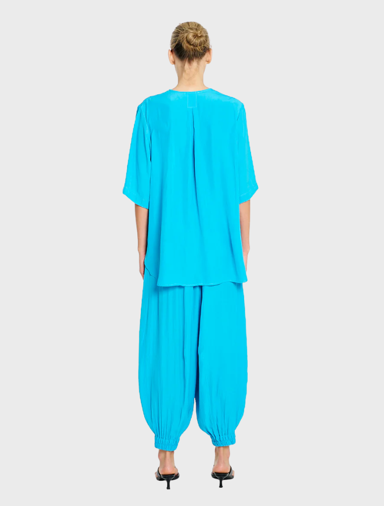  Modern cerulean Swish Plaza Top, crafted from lightweight material, offering a chic look for any casual or formal event.