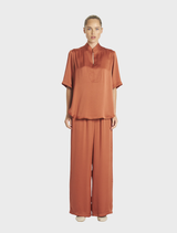Swish Tux Plaza in a rich copper hue, emphasizing its elegant and modern architectural style.