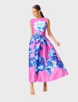 A feminine midi dress in pink and blue floral print, with cap sleeves and a contemporary back cutout, suitable for special occasions.