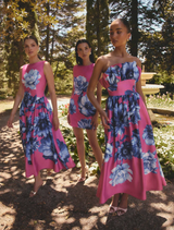 Elegant A-line midi dress featuring a pink base with blue florals, boat neckline, cap sleeves, and a flattering skirt.