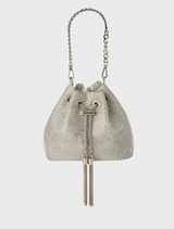 Small leather bucket bag in silver with a tassel on the handle, identified as the Sylvie Crystal Pouch.