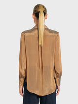 The Syrup Chiffon Atrium Blouse features a crisp collar, gathered sleeves, and a luminous two-tone design for added elegance.