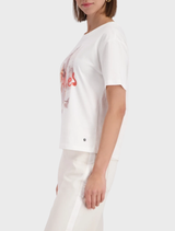 Off-White T-shirt and sleek sneakers displayed together, highlighting a trendy and casual ensemble.