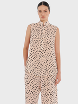 Model wearing a pink polka dot top and pants, showcasing the Tab Slide Tank in Meringue/Black design.