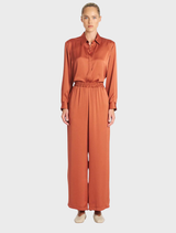 Copper Maxi Pace Pant laid flat, emphasizing its smooth fabric and tailored fit.