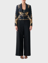 High-waisted tailored pant in silk-wool with waist button detail, inspired by matador costumes and elegant tailoring.