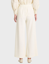 Vanilla and black suit pants arranged neatly, illustrating a sophisticated look ideal for business attire.