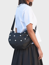 Elegant black dome-shaped bag, designed for versatility, with comfortable handles and a chic appearance.