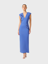 A cornflower blue column dress by Talitha with a plunging neckline, showcased on a mannequin to emphasize its chic style.