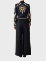 Elegant high-waisted tailored pant featuring waist button detail, crafted from silk-wool, inspired by matador costumes.