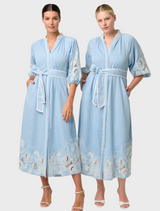 Two women wearing blue embroidered maxi dresses, showcasing the Amara Tencel design in Blue Haze.