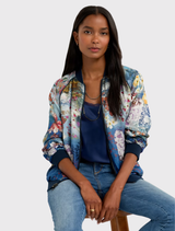 Stylish reversible bomber jacket with a soft ombre effect, floral embroidery, and blue ribbing, perfect for layered outfits.