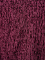 Close-up of burgundy fabric featuring fringes, showcasing its texture and rich color.