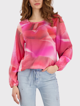 Monari blouse featuring a pink floral pattern, round neckline, long sleeves, and elastic cuffs and hem for a stylish look.