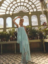 Light blue strapless dress adorned with fringes, highlighting a stylish and breezy appearance.