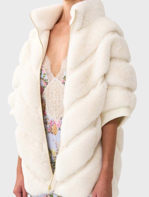 Cozy faux fur slouch jacket with short sleeves, featuring a unique tiled pattern for a trendy, relaxed look.