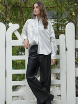 Black Track-Tic Pant displayed on a hanger, showcasing a sleek design suitable for athletic and casual wear.