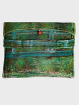 A cozy travel blanket depicting a picturesque Japanese footbridge set amidst vibrant nature and calm waters.