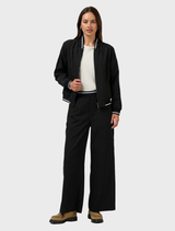 A black Trax reversible jacket is shown, highlighting its modern look and adaptability for different outfits.