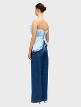 Baby blue Tremail top on a hanger, highlighting its clean lines and comfortable material for casual fashion.