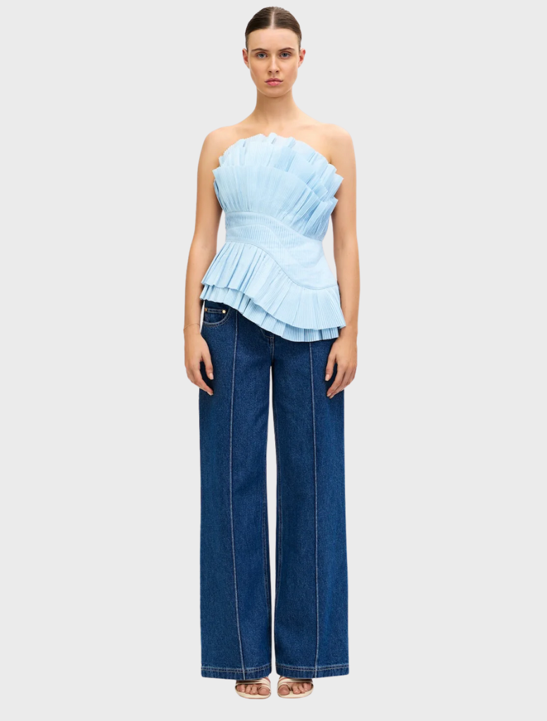Baby blue Tremail top displayed on a hanger, featuring a simple design and lightweight fabric suitable for casual wear.