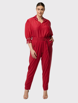Elegant dahlia red tailored jogger pants with silky fabric, elastic button cuffs, and utility pockets for versatile styling.