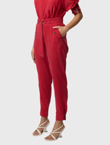 Trendy dahlia red jogger pants crafted from silky cupro-viscose, showcasing tapered cuffs and functional pocket details.