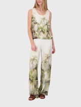 Lightweight olive palazzo pants with a tropical print and satin finish, ideal for stylish summer outings.