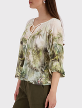 100% viscose blouse in olive with a tropical design, round neckline, and ¾ sleeves, perfect for warm summer days.