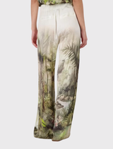 Olive tropical print palazzo pants, lightweight and satin-like, perfect for enjoying warm summer days in style.