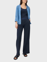 Model wearing a blue shirt paired with navy wide trousers, showcasing a stylish and relaxed outfit.