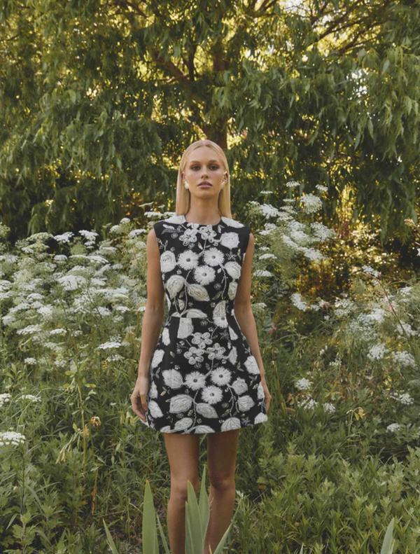 A black and white dress featuring floral designs that mimic the appearance of a flower in full bloom.