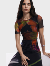 A black dress with an elegant floral print, highlighting a mix of bright flowers against a dark background.