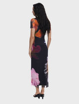 A chic black dress decorated with a lively floral pattern, combining sophistication and style.