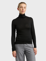 Black turtle neck merino tee displayed on a hanger, showcasing its soft fabric and elegant design.