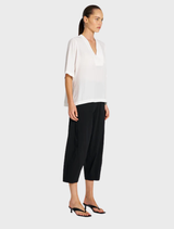 Stylish black cropped Tuscan pants presented, focusing on their chic design and tailored look suitable for various occasions.